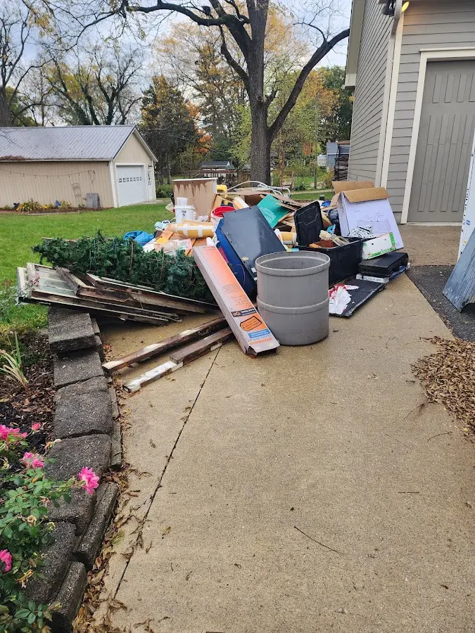 Dumpster being loaded with debris for Commercial Dumpster Rental in Utica